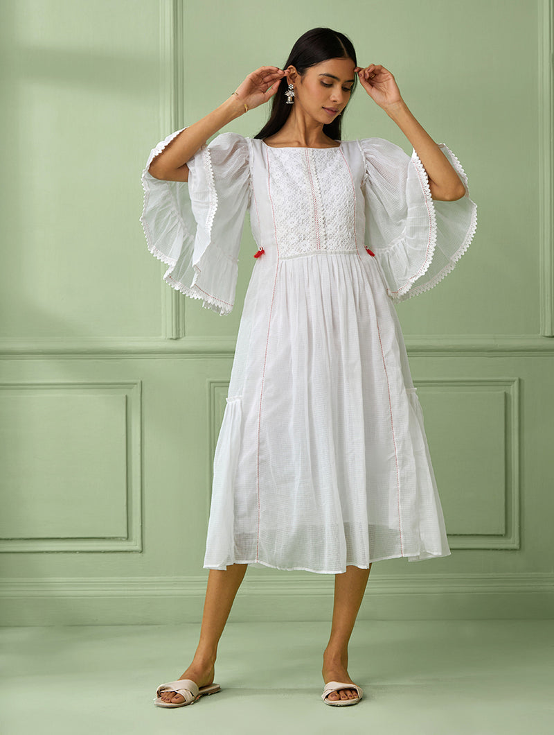 Flared lace white dress in cotton with flared sleeves and red tassels Sonal Kabra