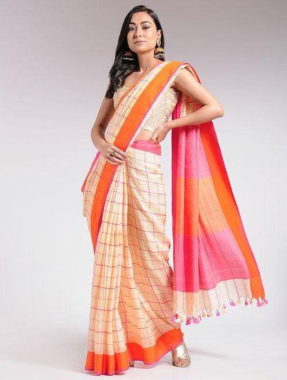 Big checked Ivory Orange and Pink linen saree with orange and pink border sunset colours pink and orange pallu with tassels of ivory and pink mat finish with bold checks pattern social gatherings comfortable and breathable fabric summer spring collection unstitched blouse piece, best seller of the collection, The Neem Tree Sonal Kabra , sustainable cotton linen fabric , summer friendly, end of season sale